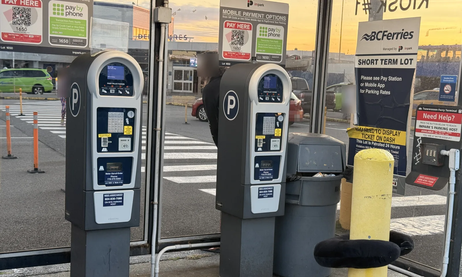 Two Impark pay stations for the short-term lot at Tsawwassen Ferry Terminal, with a Pay Here sign and a BC Ferries Short Term Lot notice