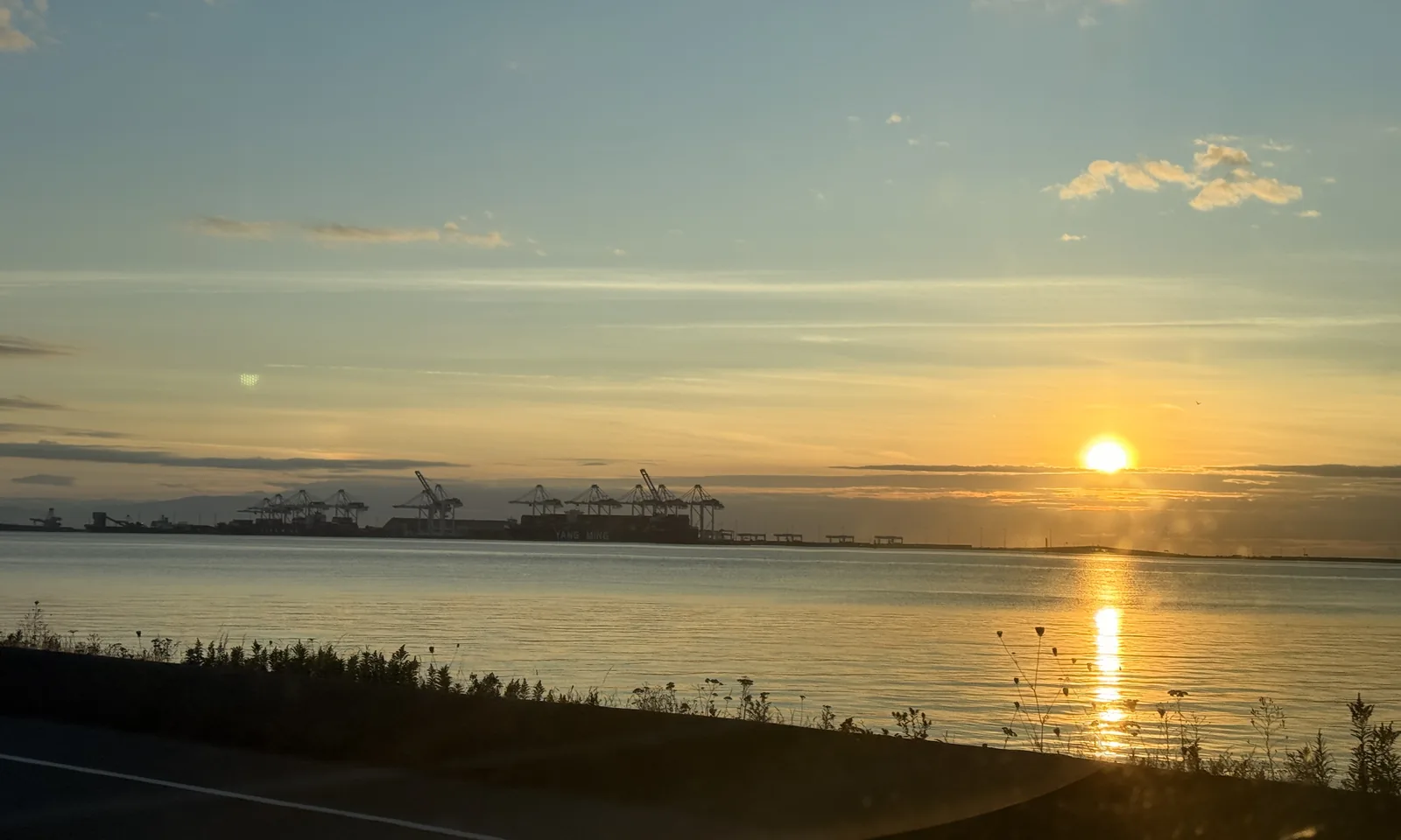 Sunset over Roberts Bank from the Tsawwassen causeway, with the Deltaport container cranes on the horizon